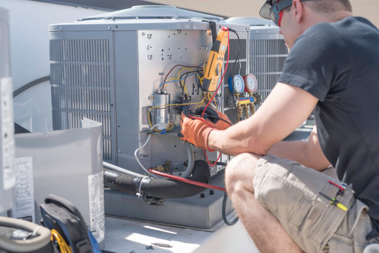 A technician servicing a condenser