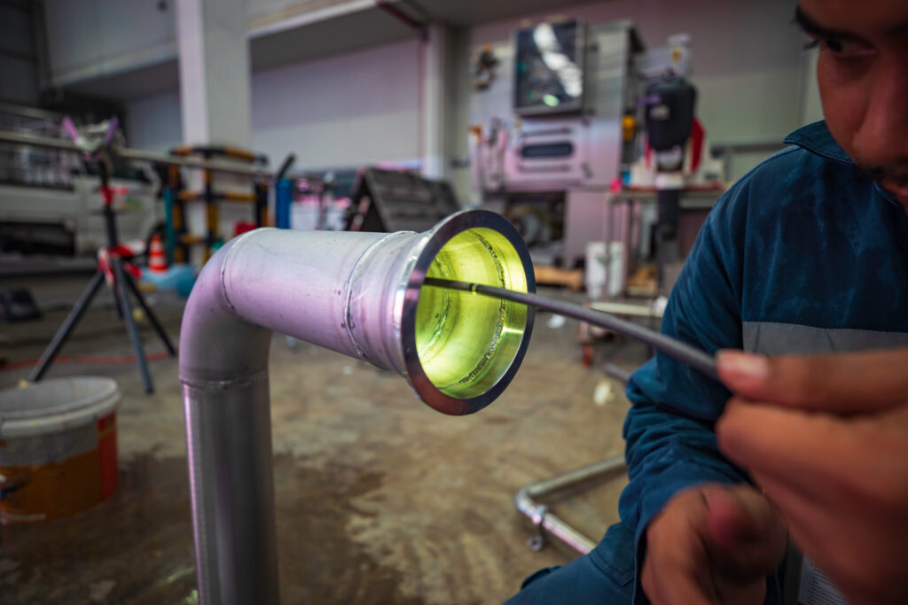 A man uses a camera to inspect a pipe