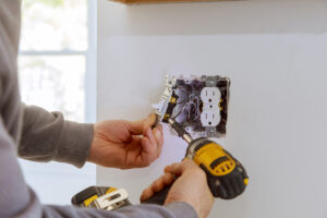 An electrician working on outlets