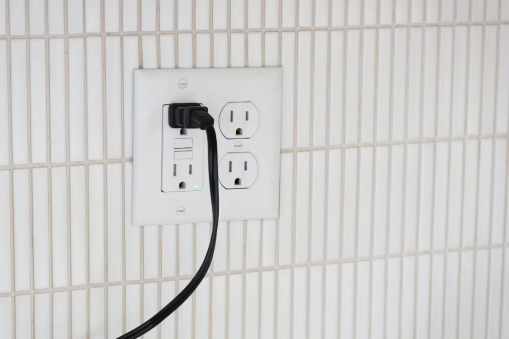 Electrical outlet with cord plugged in